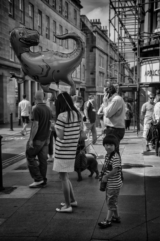 dinosaur balloon and camera boy - UK street Photography