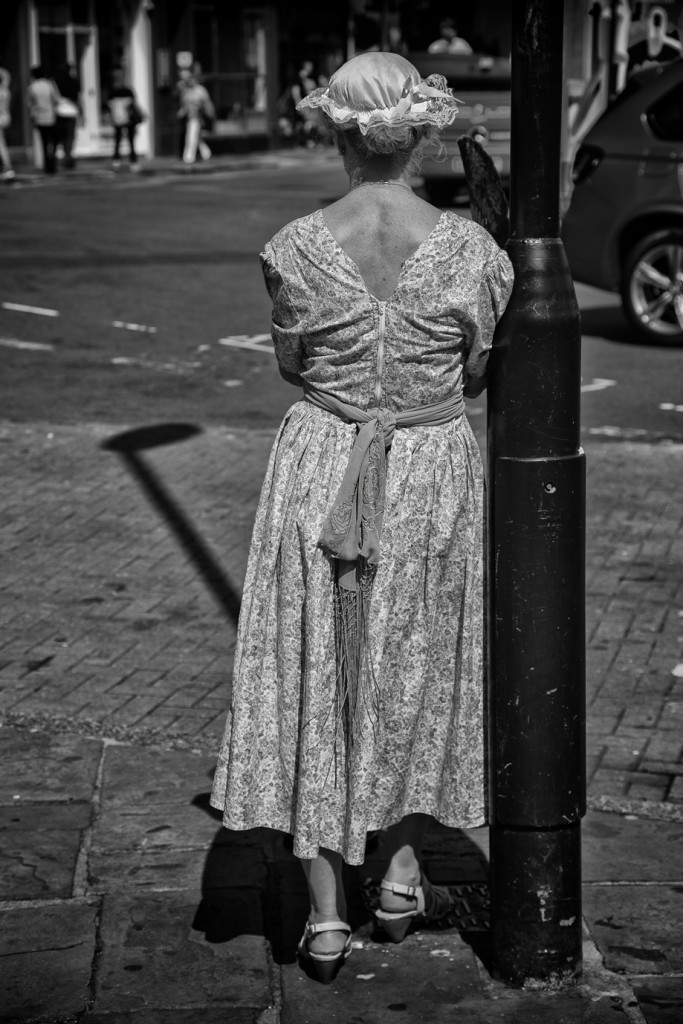 lamp post lady - UK street Photography